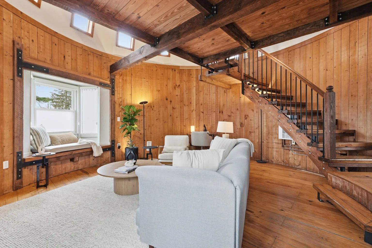 The Silo living room with upper windows and curved staircase